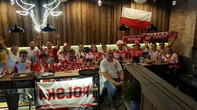 Kibice reprezentacji Polski oglądają mecz w Wół i Spółka pod neonem byka